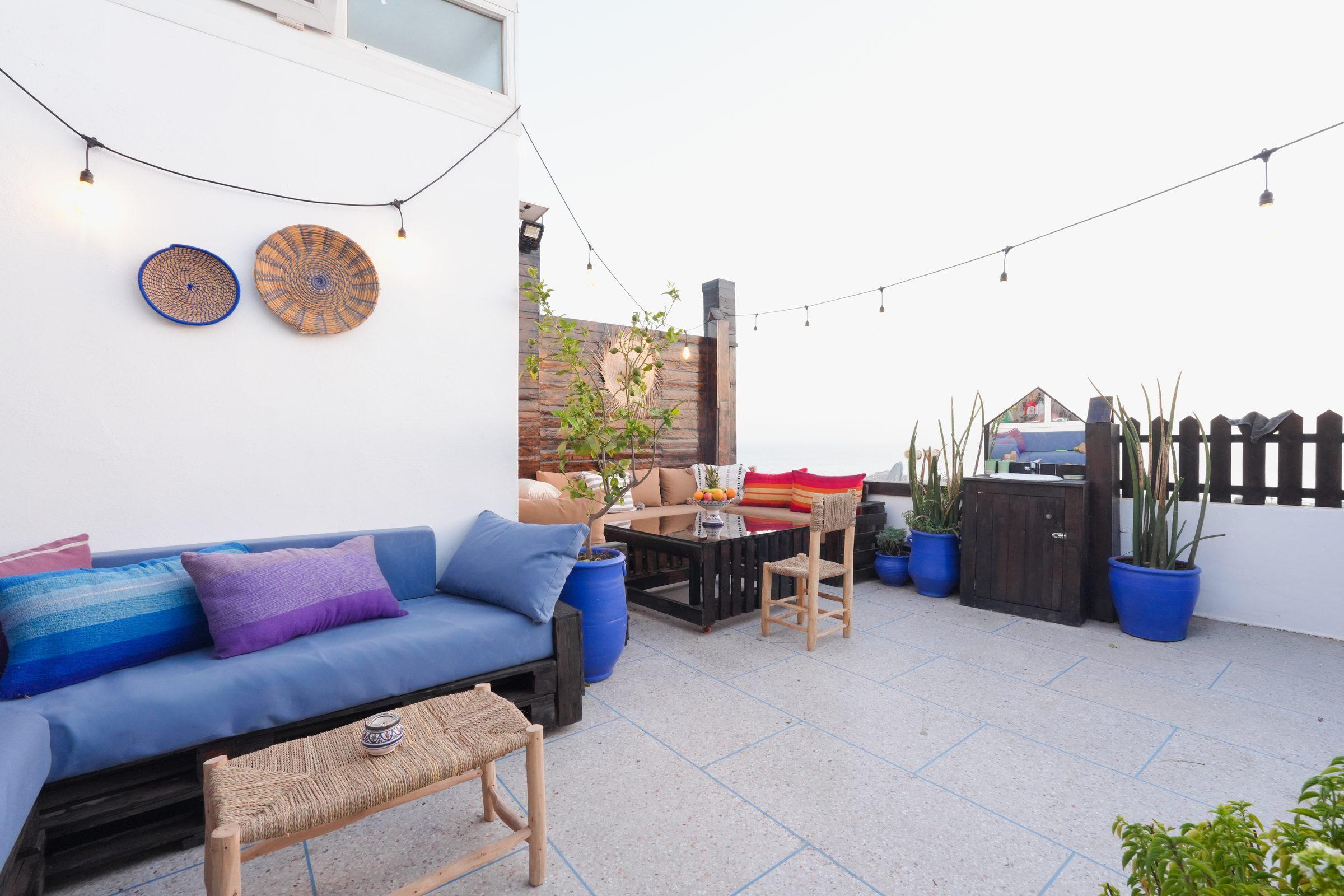 Terrace lounge seating with cushions and plants